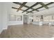 Open-concept living space featuring hardwood floors, modern lighting, and a view of kitchen at 11622 Gleaming Ter, Venice, FL 34293