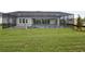 View of the pool and screened-in patio from the grassy backyard at 11622 Gleaming Ter, Venice, FL 34293