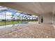 The screened-in pool area has brick pavers, a beautiful pool, and a connected hot tub at 11622 Gleaming Ter, Venice, FL 34293