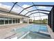 Screened-in pool and patio area with brick pavers and connected hot tub at 11622 Gleaming Ter, Venice, FL 34293