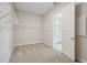 Spacious walk-in closet with carpet, wire shelving, and an open door to a bathroom for convenience at 11622 Gleaming Ter, Venice, FL 34293