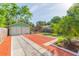 Lush backyard featuring a charming garage and inviting pergola, offering a peaceful outdoor retreat at 1202 E Mohawk Ave, Tampa, FL 33604