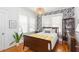 Comfortable bedroom with a bed and decorative wallpaper at 1202 E Mohawk Ave, Tampa, FL 33604