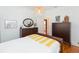 Bedroom featuring a comfortable bed, natural lighting, and dark wood furniture at 1202 E Mohawk Ave, Tampa, FL 33604