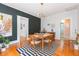 Dining room featuring a modern light fixture, hardwood floors, and white trim at 1202 E Mohawk Ave, Tampa, FL 33604