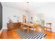 Dining room featuring hardwood floors, modern lighting, and decorative accents at 1202 E Mohawk Ave, Tampa, FL 33604