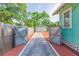 Charming home with a backyard accessed via a gated entrance, featuring a lush yard with a detached garage at 1202 E Mohawk Ave, Tampa, FL 33604