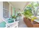 Inviting front porch with chairs and plants creating a cozy outdoor living space, great for relaxing at 1202 E Mohawk Ave, Tampa, FL 33604