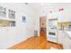 Bright kitchen with white cabinets, stainless steel appliances, and hardwood floors at 1202 E Mohawk Ave, Tampa, FL 33604