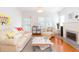 Bright living room featuring hardwood floors, a fireplace, and plenty of natural light with stylish décor at 1202 E Mohawk Ave, Tampa, FL 33604