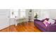 Sunlit living room featuring hardwood floors and a comfortable purple couch at 1202 E Mohawk Ave, Tampa, FL 33604