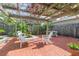 Inviting pergola with seating area, providing a serene outdoor space surrounded by lush greenery at 1202 E Mohawk Ave, Tampa, FL 33604