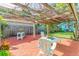 Charming outdoor pergola with seating, perfect for relaxing in a private garden setting at 1202 E Mohawk Ave, Tampa, FL 33604