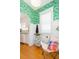 Bright sitting area with white trim and a butterfly chair, adjacent to the kitchen at 1202 E Mohawk Ave, Tampa, FL 33604