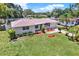 Charming single-story home featuring a lush green lawn, blooming flowerbeds, and a lovely front yard at 1223 Jasmine Way, Clearwater, FL 33756