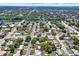 Expansive aerial view of a neighborhood, highlighting the streets, houses, and lush greenery at 1223 Jasmine Way, Clearwater, FL 33756