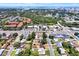 Aerial view of a coastal city neighborhood, showing rooftops, green spaces, and a distant waterfront at 1223 Jasmine Way, Clearwater, FL 33756