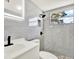 Modern bathroom with beautiful tile, LED mirror, and black fixtures at 1223 Jasmine Way, Clearwater, FL 33756