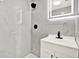 Modern bathroom showcasing tiled walls, a shower, and a vanity at 1223 Jasmine Way, Clearwater, FL 33756
