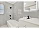 Elegant bathroom with modern fixtures, stylish tile, and a well-lit mirror over a vanity at 1223 Jasmine Way, Clearwater, FL 33756