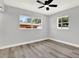 Bright bedroom featuring modern ceiling fan, neutral walls, new flooring and plenty of natural light at 1223 Jasmine Way, Clearwater, FL 33756