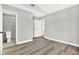 Bright bedroom with wood-look floors and access to the bathroom at 1223 Jasmine Way, Clearwater, FL 33756