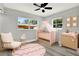 Delightful Bedroom decorated with a pink theme, featuring a crib, a rocker and changing table at 1223 Jasmine Way, Clearwater, FL 33756