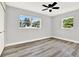 Bright bedroom featuring modern ceiling fan, neutral walls, new flooring and plenty of natural light at 1223 Jasmine Way, Clearwater, FL 33756