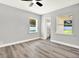 Bright bedroom featuring modern ceiling fan, neutral walls, new flooring and plenty of natural light at 1223 Jasmine Way, Clearwater, FL 33756