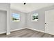 Charming bedroom with two windows and wood-look floors at 1223 Jasmine Way, Clearwater, FL 33756