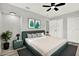 Stylish bedroom showcasing a green upholstered bed frame and a patterned rug on top of hardwood flooring at 1223 Jasmine Way, Clearwater, FL 33756