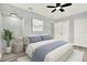 Cozy bedroom features a neutral palette, a comfortable bed with blue accents, and ample natural light at 1223 Jasmine Way, Clearwater, FL 33756