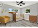 Charming Bedroom with a crib, a yellow armchair, and matching dresser, creating a cozy atmosphere at 1223 Jasmine Way, Clearwater, FL 33756