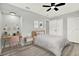 Bright bedroom featuring a desk and chair alongside a comfortable bed with a neutral color scheme at 1223 Jasmine Way, Clearwater, FL 33756