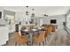 Bright dining room with modern lighting, stylish furnishings, and easy access to kitchen at 1223 Jasmine Way, Clearwater, FL 33756