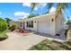 Inviting home exterior with a well-manicured lawn and a garage at 1223 Jasmine Way, Clearwater, FL 33756
