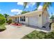 Well-maintained home featuring a single-car garage, neat landscaping and a paved driveway at 1223 Jasmine Way, Clearwater, FL 33756