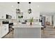 Modern kitchen with island, stylish pendants, and stainless steel appliances at 1223 Jasmine Way, Clearwater, FL 33756