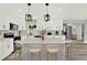 Modern kitchen with island, stylish pendants, and stainless steel appliances at 1223 Jasmine Way, Clearwater, FL 33756