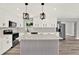 Bright, renovated kitchen with white cabinets, stainless steel appliances, and a stylish center island at 1223 Jasmine Way, Clearwater, FL 33756
