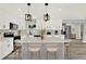 Modern kitchen featuring white cabinets, an island with seating, and stainless steel appliances at 1223 Jasmine Way, Clearwater, FL 33756