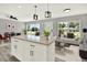 Open-concept living room featuring kitchen island, stylish furnishings, and bright, natural light at 1223 Jasmine Way, Clearwater, FL 33756