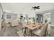 Open-concept living space blending dining, living and kitchen areas, enhanced with modern decor and new lighting at 1223 Jasmine Way, Clearwater, FL 33756
