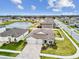 Aerial view of a single-Gathering home showing a pond, and a well-manicured lawn at 12351 Nouveau Ave, Spring Hill, FL 34610