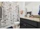 Charming bathroom with a Paris-themed shower curtain, granite countertop, and a dark wood vanity at 12351 Nouveau Ave, Spring Hill, FL 34610