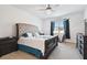 Bright bedroom with tufted headboard, ample natural light, and stylish furnishings at 12351 Nouveau Ave, Spring Hill, FL 34610