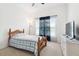 Bedroom featuring neutral walls, a wood bed frame, and a large window with patterned curtains, offering natural light at 12351 Nouveau Ave, Spring Hill, FL 34610