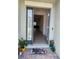 Inviting entryway with a decorative doormat, sidelight window, and tiled flooring at 12351 Nouveau Ave, Spring Hill, FL 34610