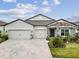 Charming one-story home features a brick-paved driveway and a three-car garage for ample parking at 12351 Nouveau Ave, Spring Hill, FL 34610