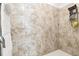 Modern tiled shower boasts handheld sprayer and built-in shelving at 12351 Nouveau Ave, Spring Hill, FL 34610